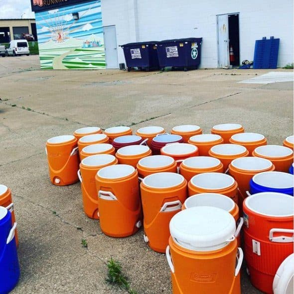 Red Dirt water jugs staged for a race